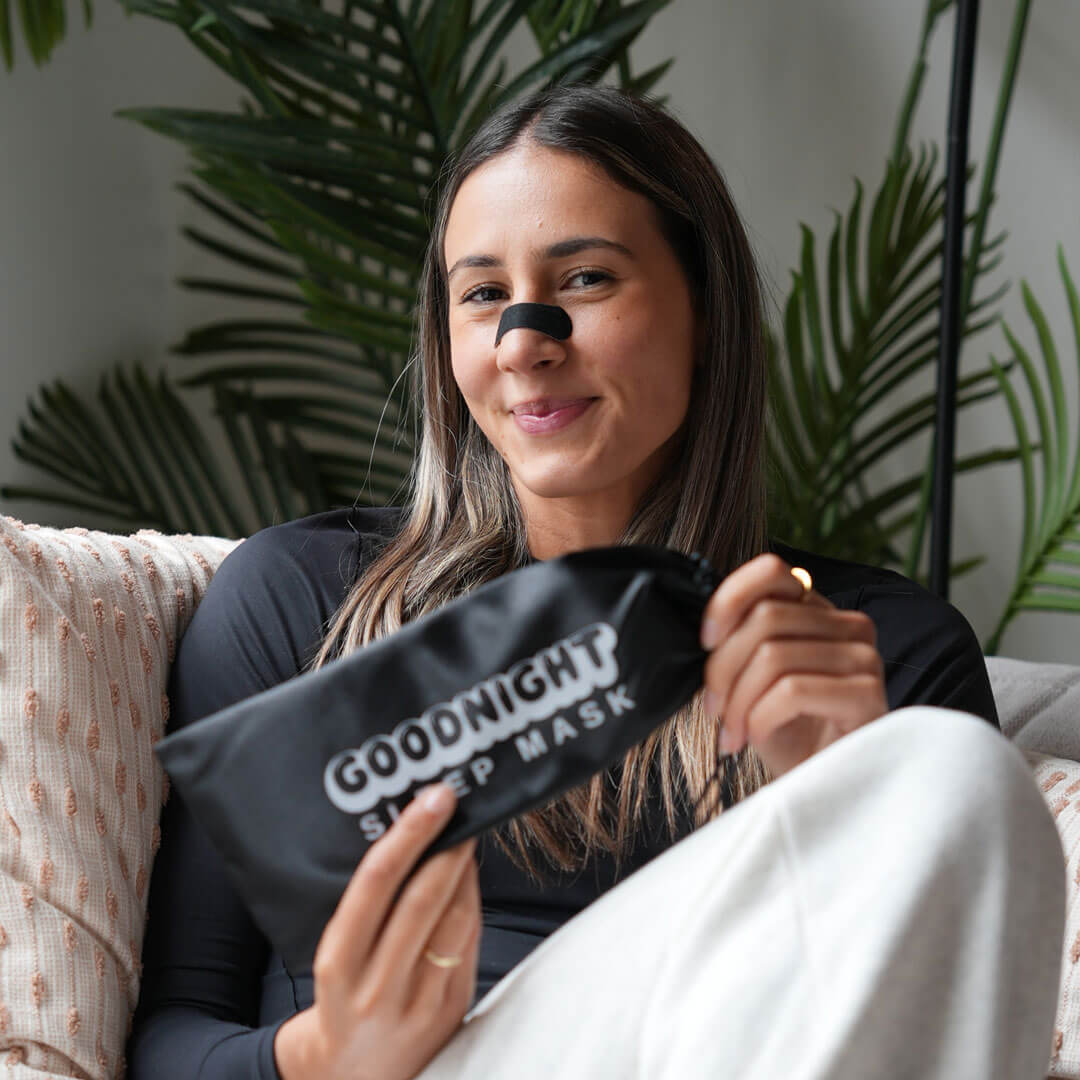 Woman holding Goodnight Tape sleep mask